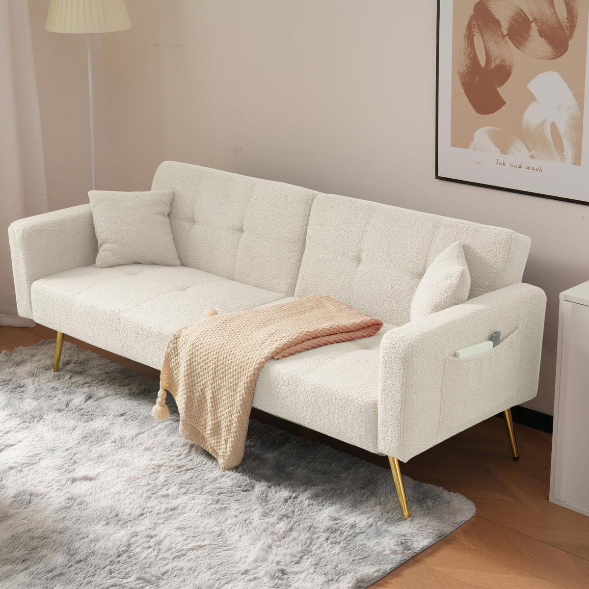 Sofá cama con esquinas ajustables, patas doradas, almohadas y bolsillos laterales para almacenamiento (Bavia)