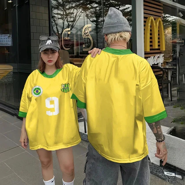 Vivodeco yellow and green oversized short sleeve jerseys worn by two people outside a storefront, featuring a Brazil crest and large white number on the front shirt