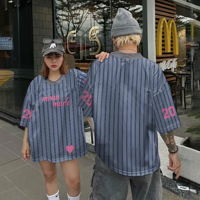 Vivodeco oversized blue striped short sleeve shirt modeled by two people outside a cafe, featuring pink number graphics and a relaxed hip hop style