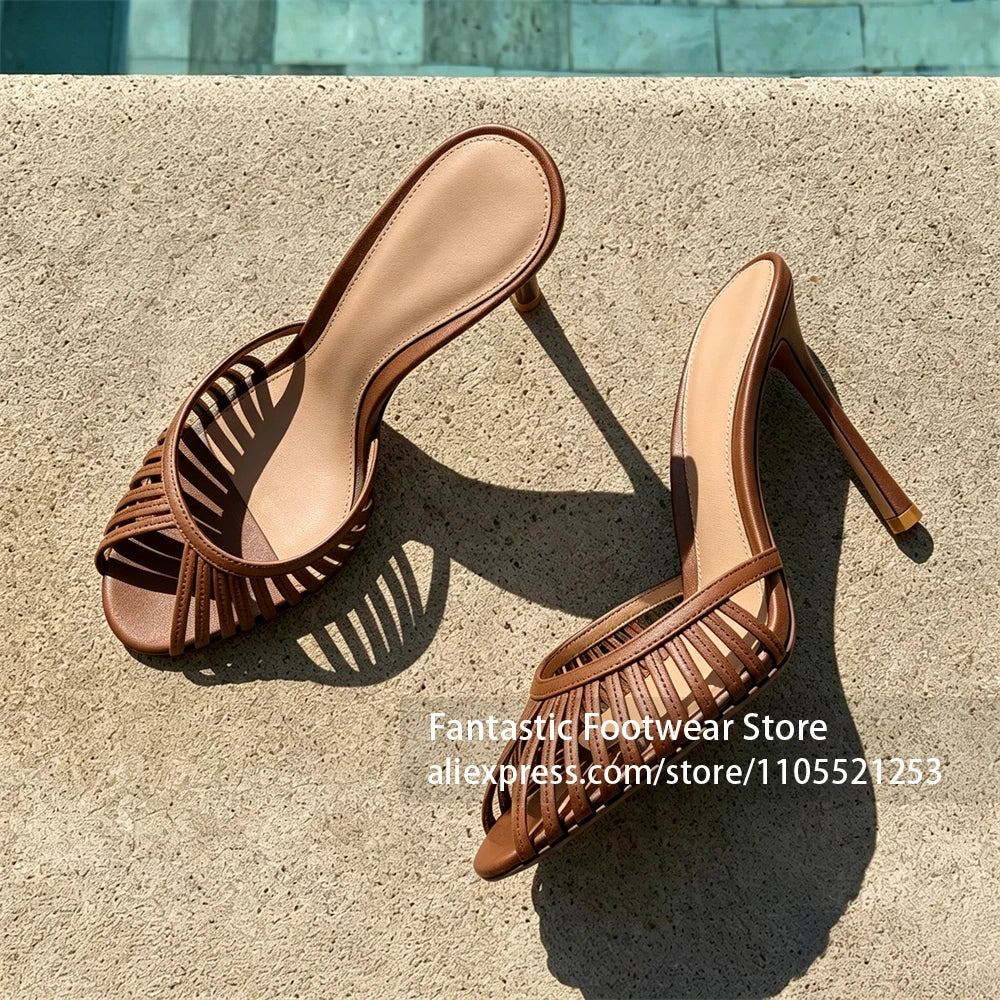 Vivodeco tan mule sandals with slim strappy round toes and high stiletto heels displayed on a sunlit concrete surface outdoors