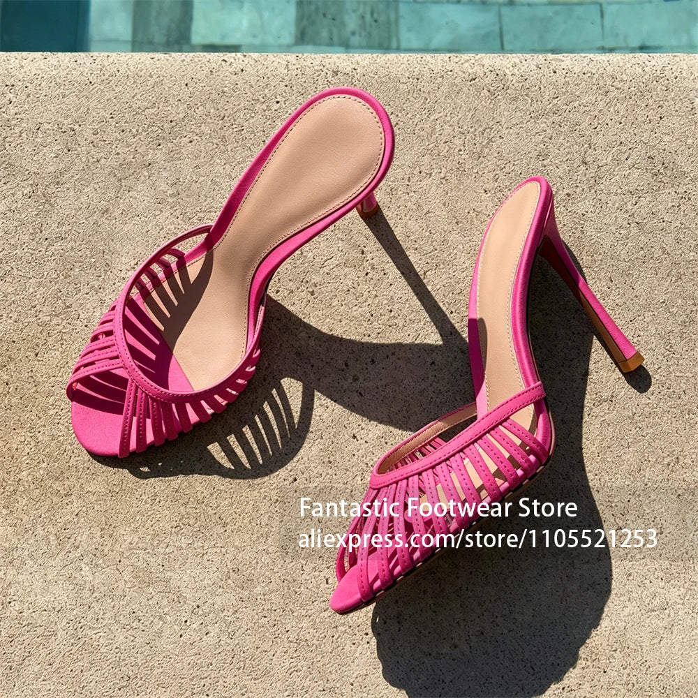 Vivodeco pink open toe sandals with narrow straps, rounded toes, and slim stiletto heels, displayed on a sunlit concrete surface