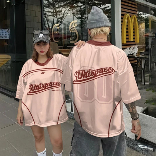 Vivodeco matching oversized pink short sleeve shirts with red trim and bold Unispace graphics, modeled outdoors in front of a storefront by two young adults