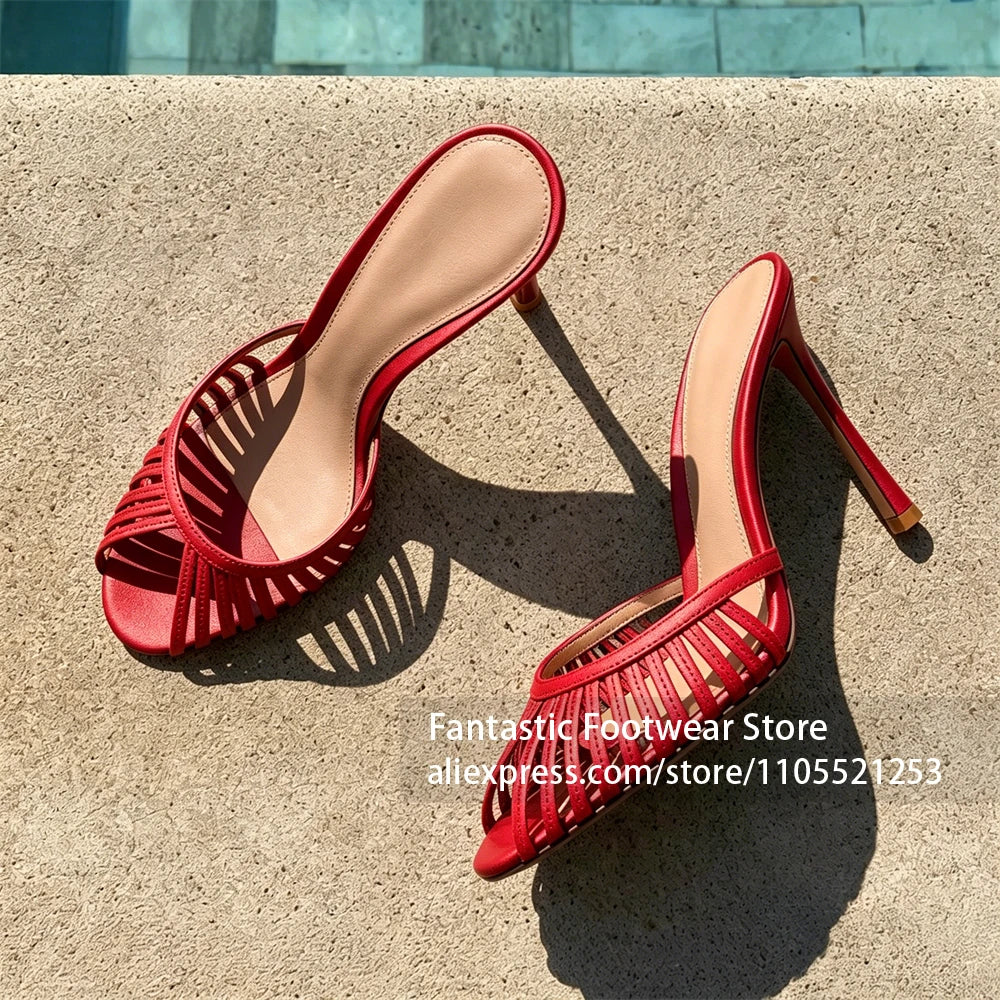 Vivodeco red strappy mule sandals with open backs and slim stiletto heels displayed on a sunlit concrete surface outdoors