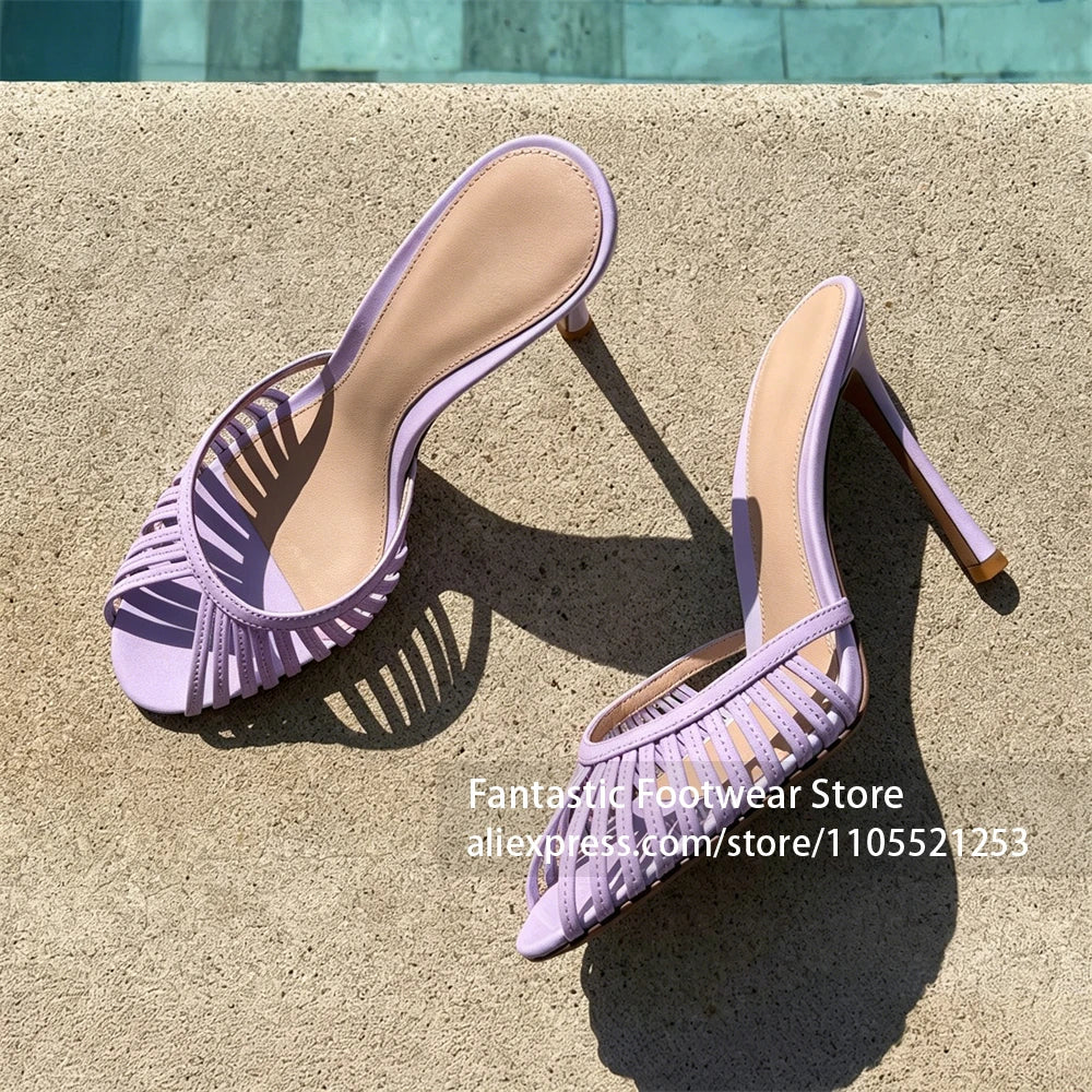 Vivodeco lavender mule sandals with slim strappy open toes and high stiletto heels displayed on a sunlit concrete surface