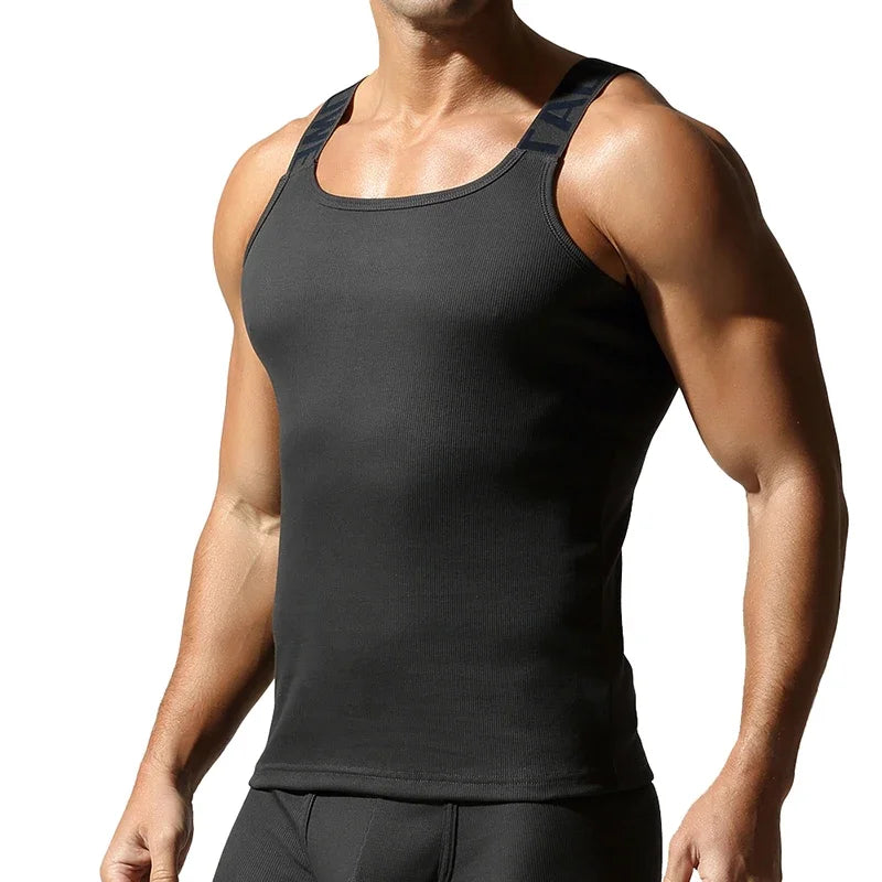 Camisetas sin mangas a la moda para hombre, chaleco deportivo de entrenamiento sin mangas, camisolas acanaladas con tirantes elásticos de Color sólido, camisetas interiores ajustadas