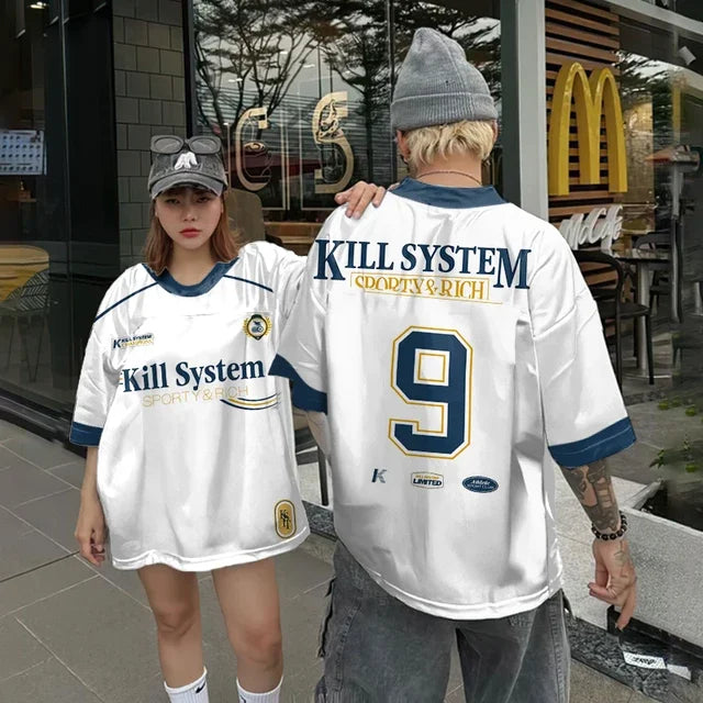 Vivodeco oversized white short sleeve shirts with navy and gold graphics worn by two people outside a storefront one showing the front and the other showing number 9 on the back
