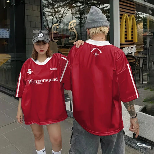 Vivodeco red oversized short sleeve shirts modeled by two people outside a storefront, showing a printed front design and graphic detail on the back.